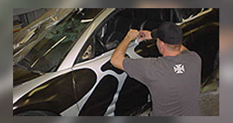 Employee Applying Graphics to Side of Car - Hydrographics